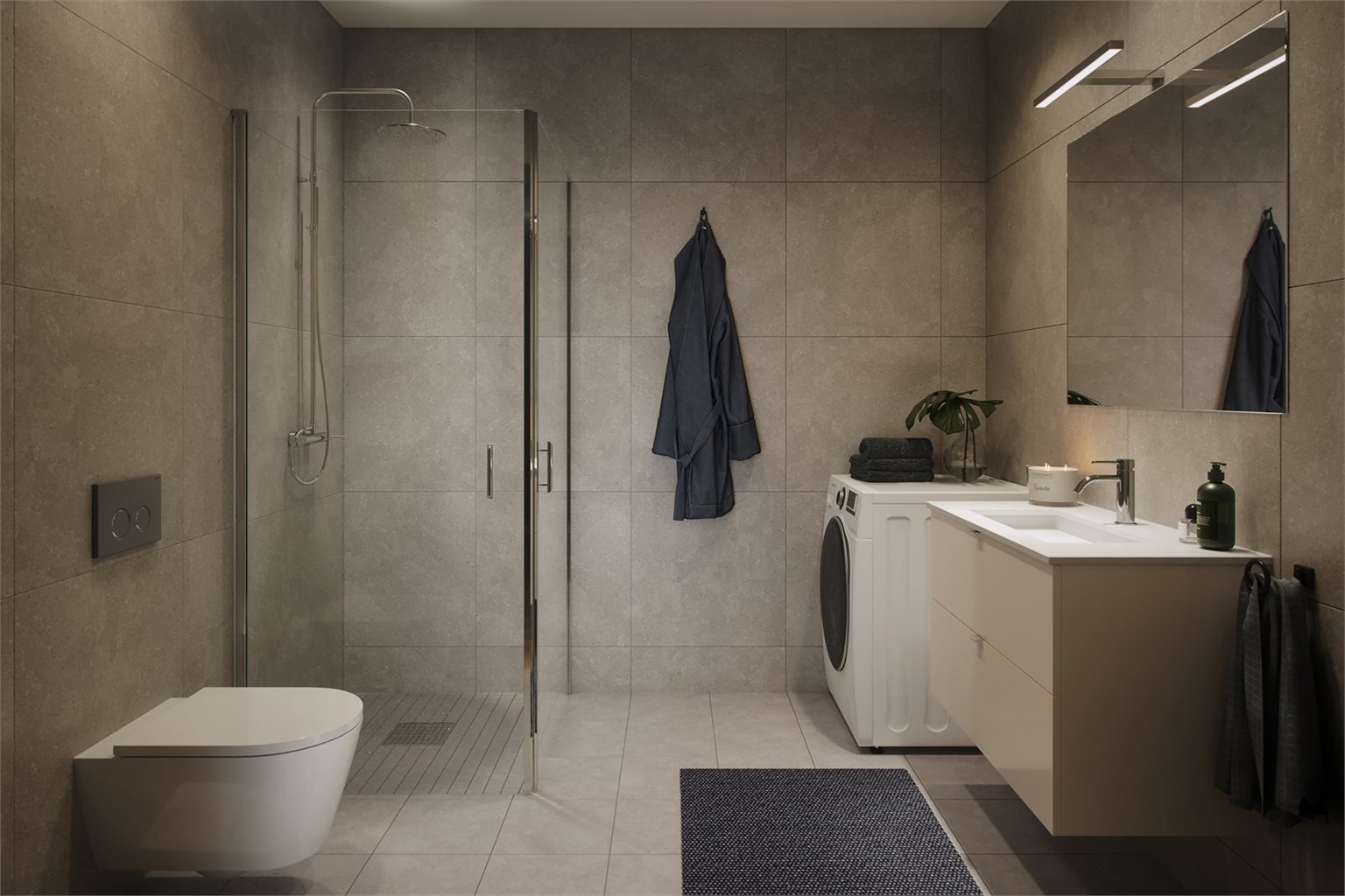 Leiligheten har et påkostet bad fra Designa. Flislagt gulv og vegger med moderne stil- og fargevalg. Det er påkostet tilvalg med rundt Ravenna speil med lys. Bildet er en illustrasjon.